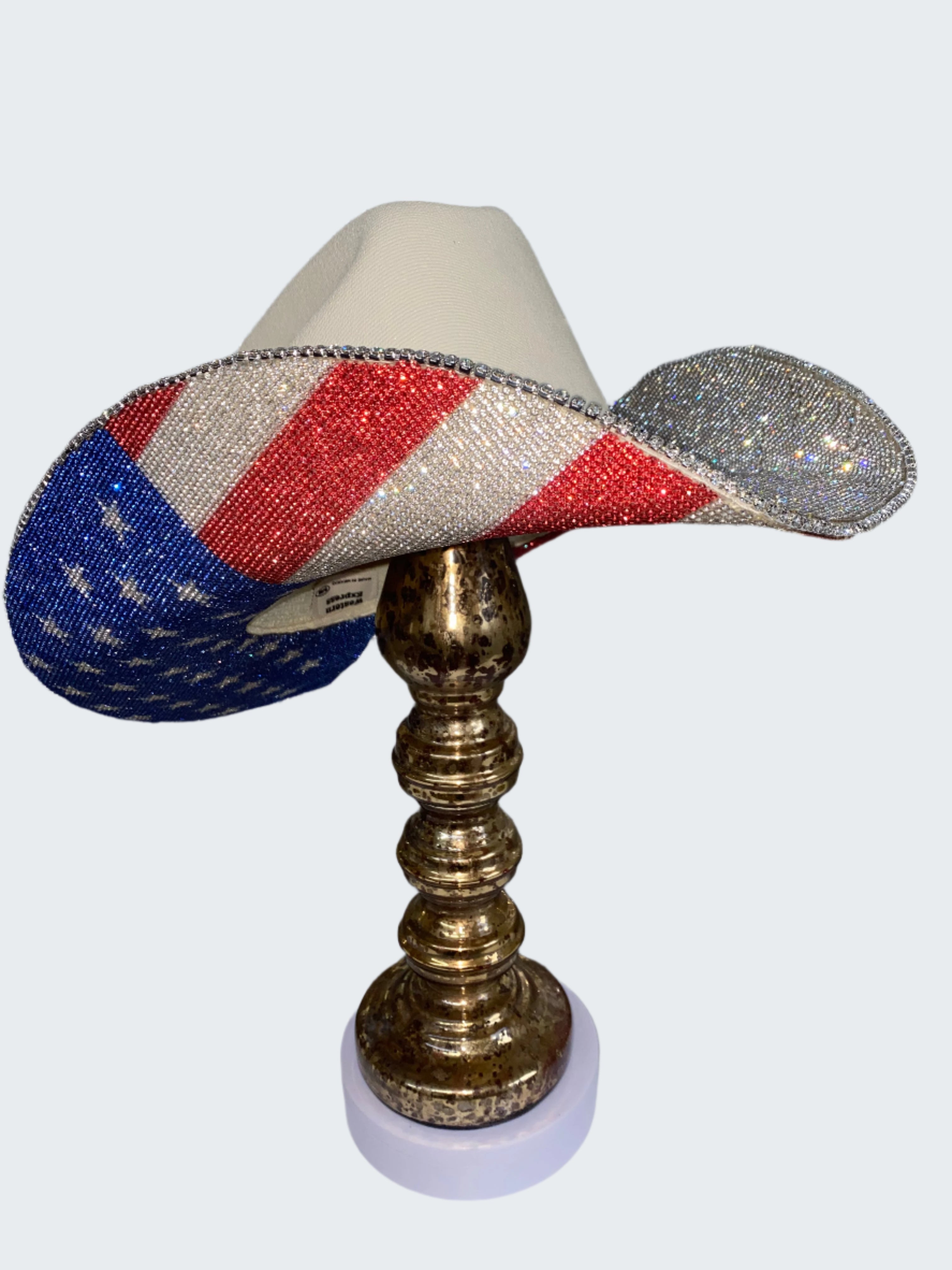 Decorative lamp with American flag design on a metallic stand against a glittery background