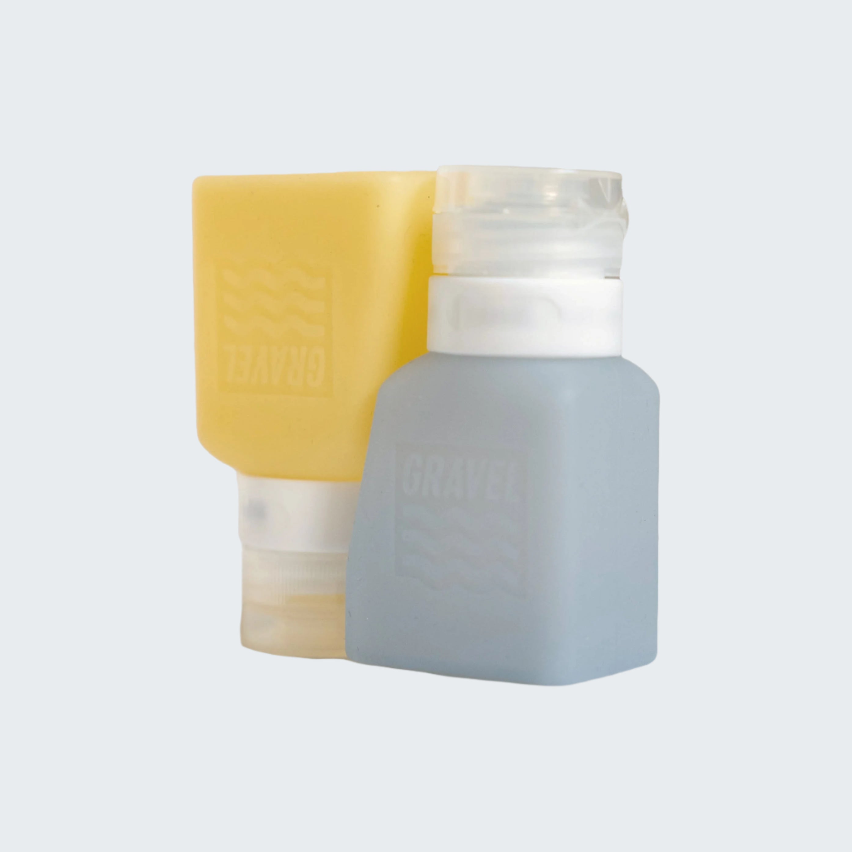 Two small containers, one yellow and one gray, with white lids on a light gray background.