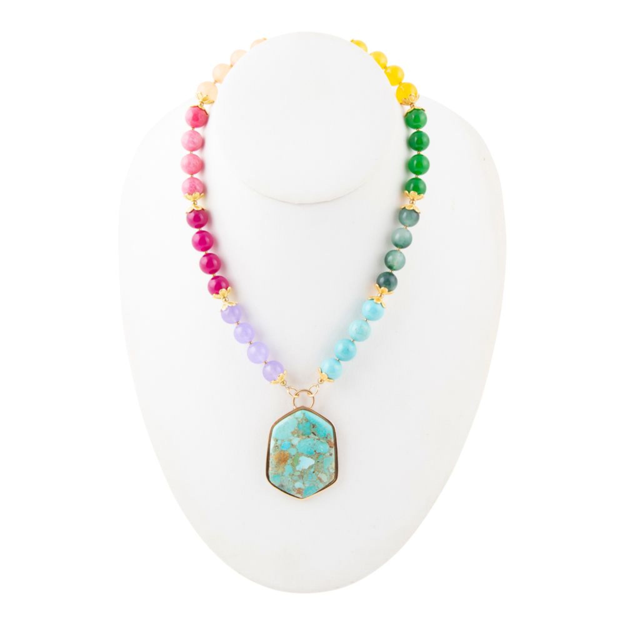 Colorful beaded necklace with a turquoise pendant on a white stand