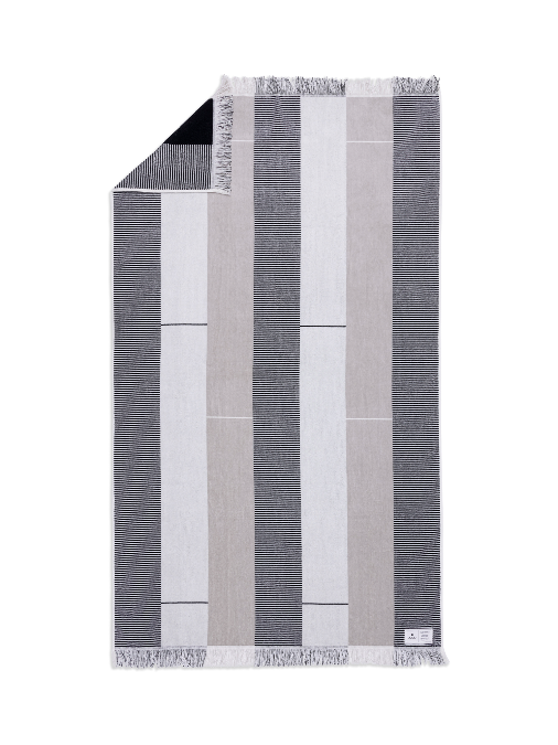 Striped towel with black, gray, and white stripes on a white background