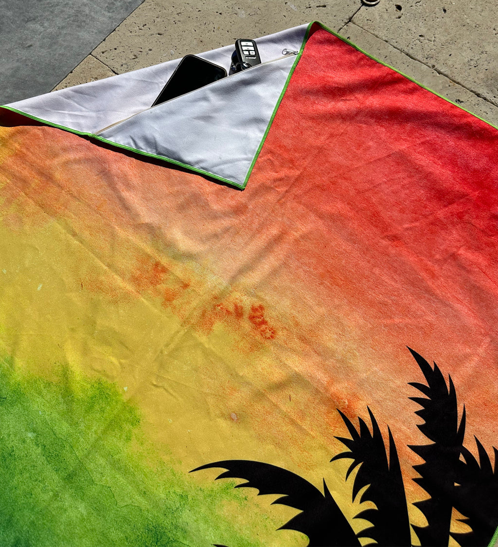 Colorful towel with a palm tree design on a sidewalk