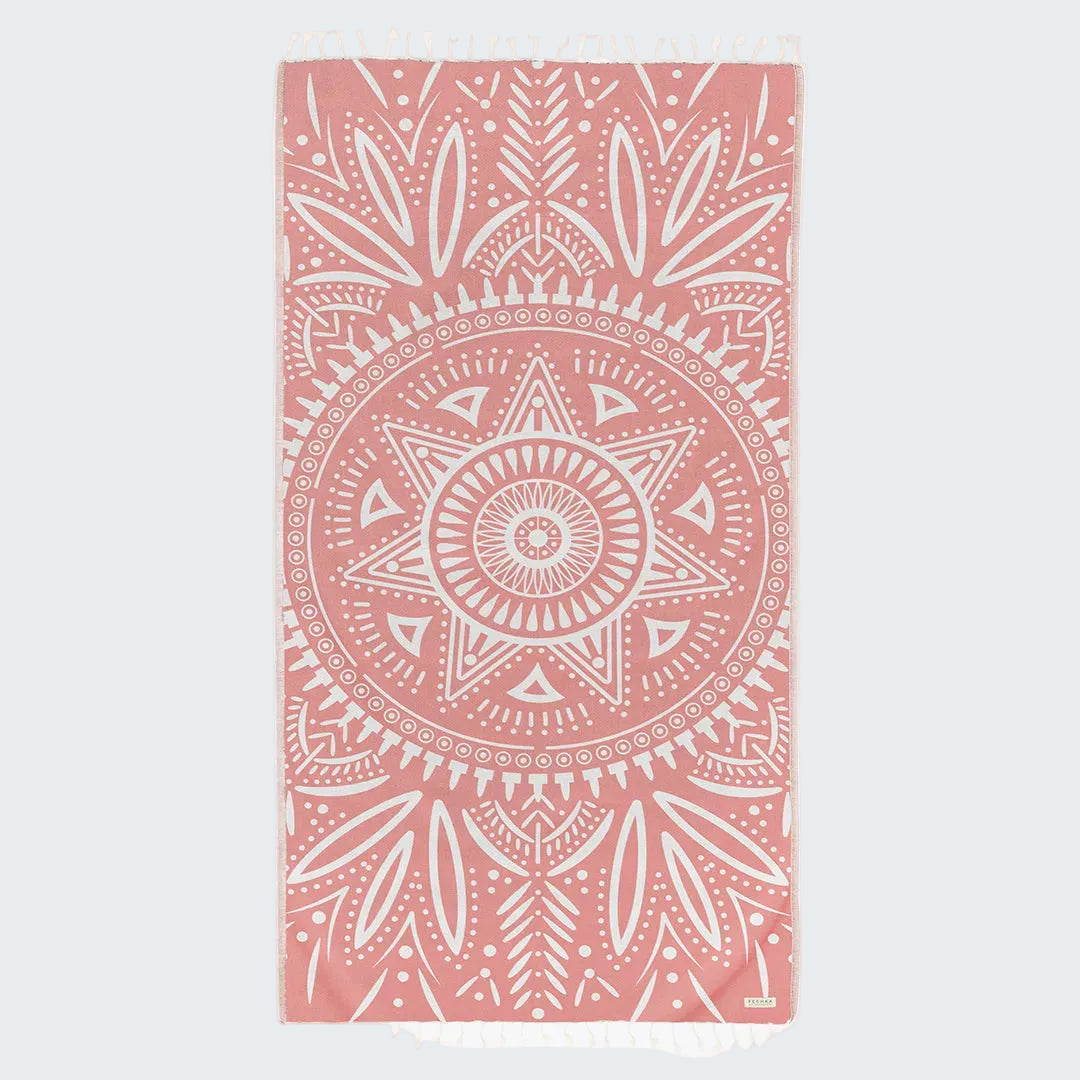 Pink towel with white geometric pattern on a white background