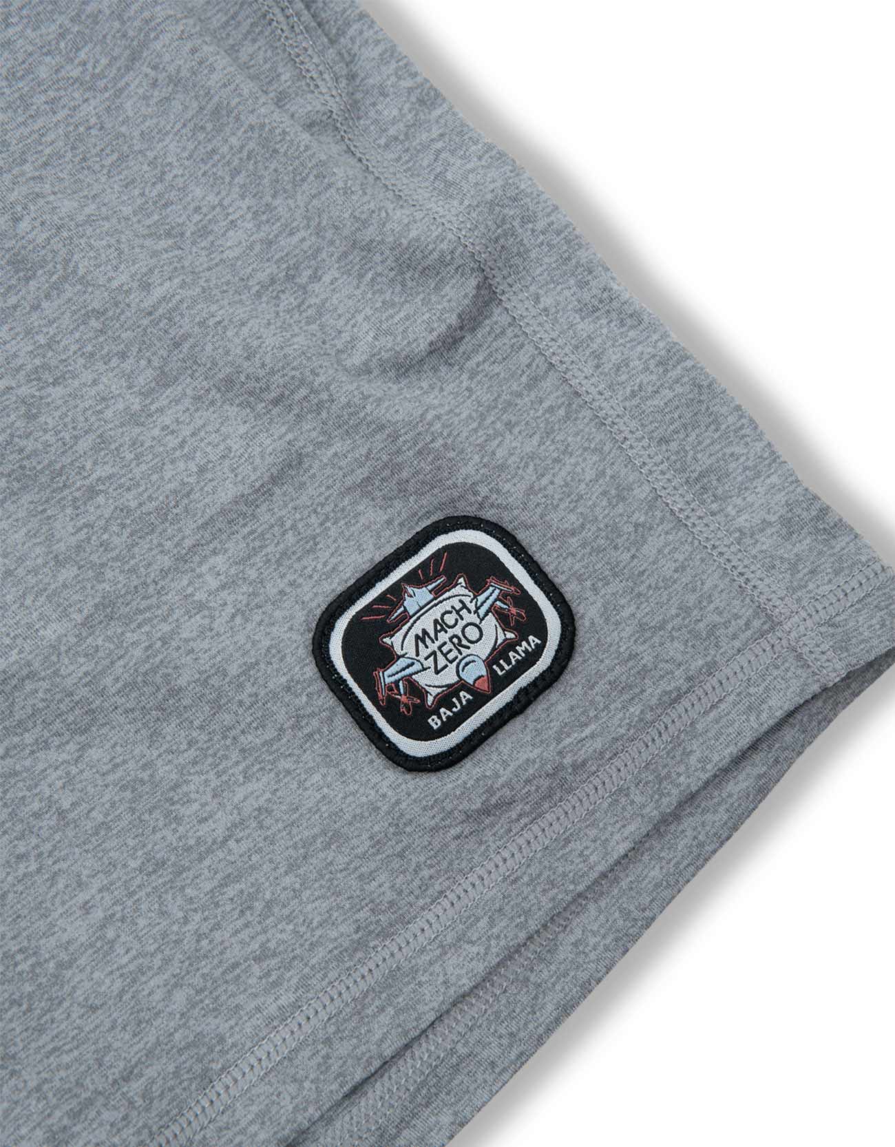 Gray shorts with a logo patch on a white background