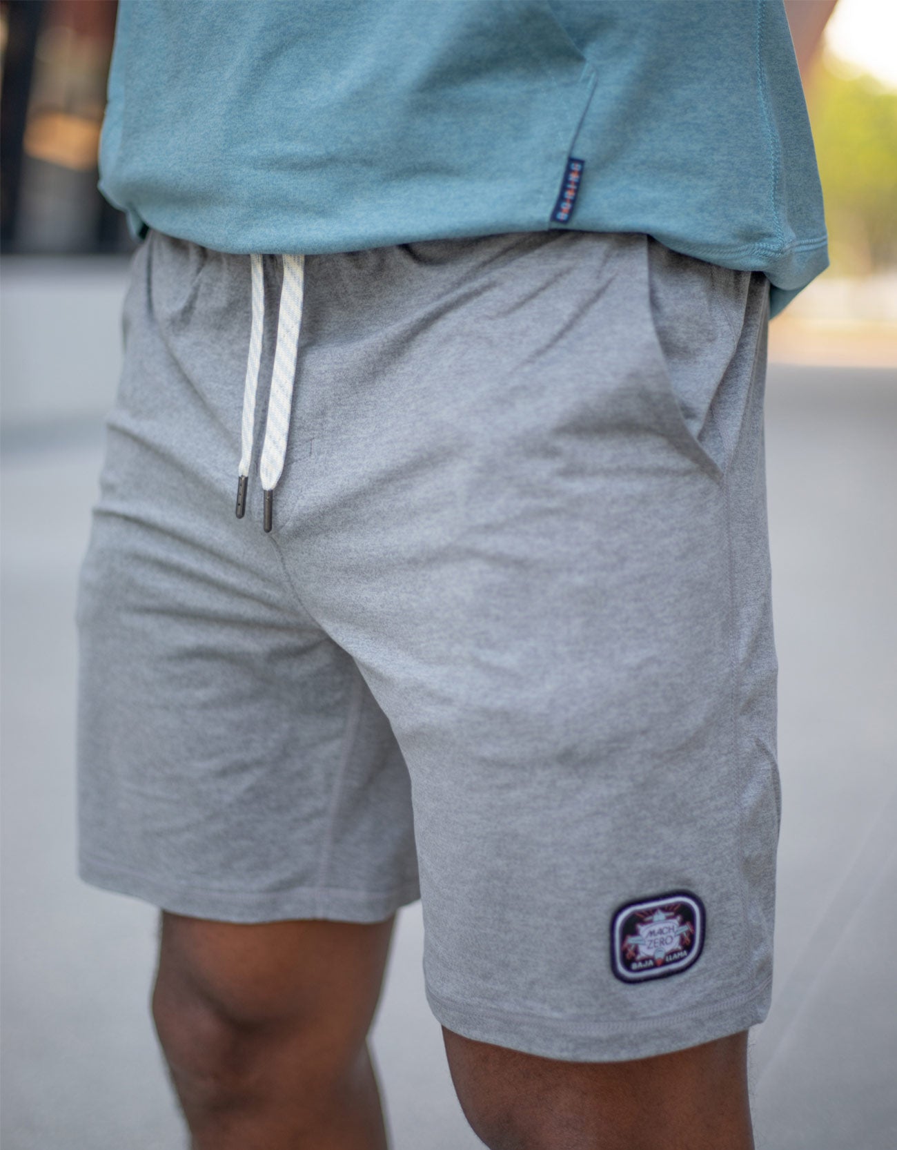 Gray shorts with a brand logo on a blurred background