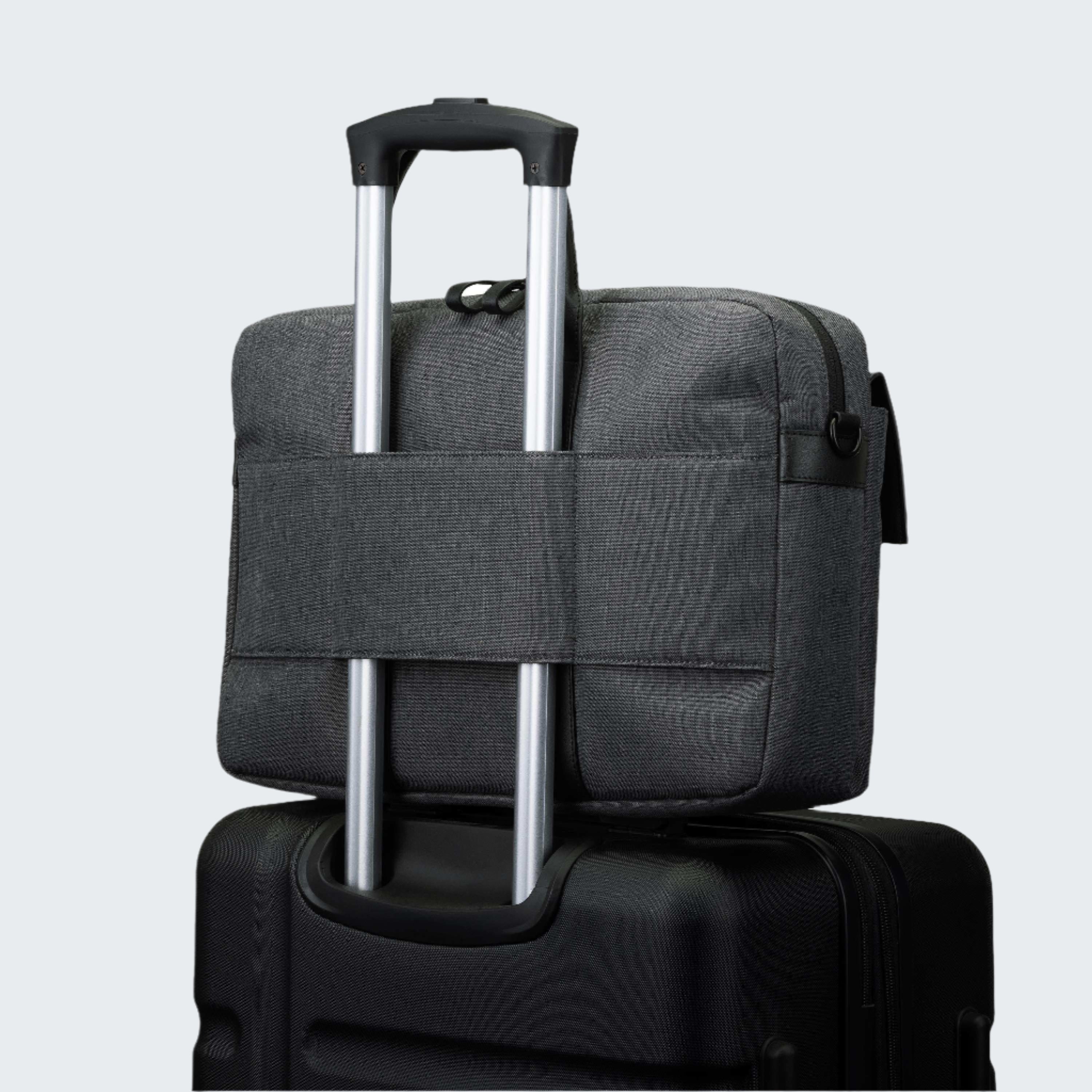 Gray suitcase with a black handle on a white background
