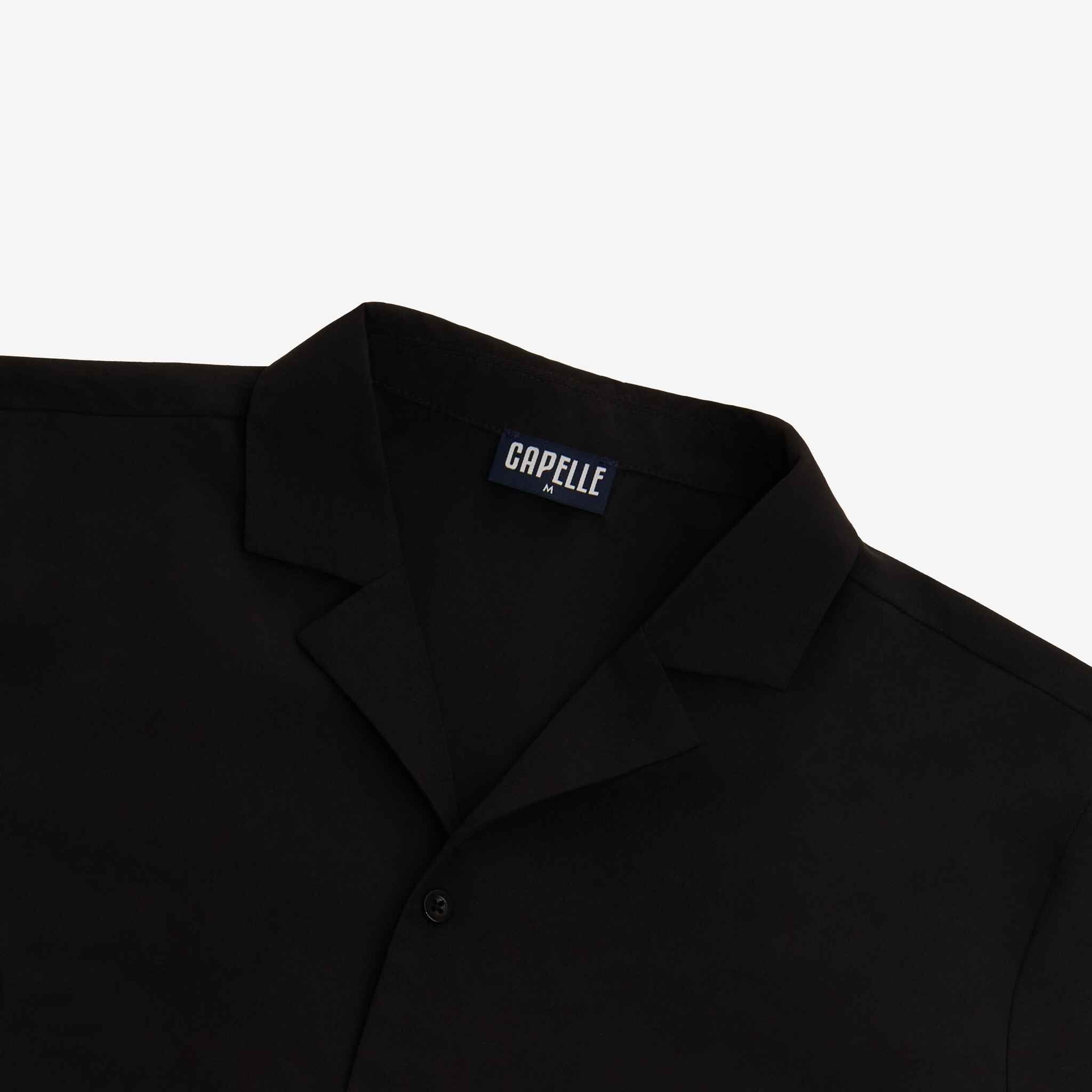 Black shirt with 'CAPELLE' label on a white background