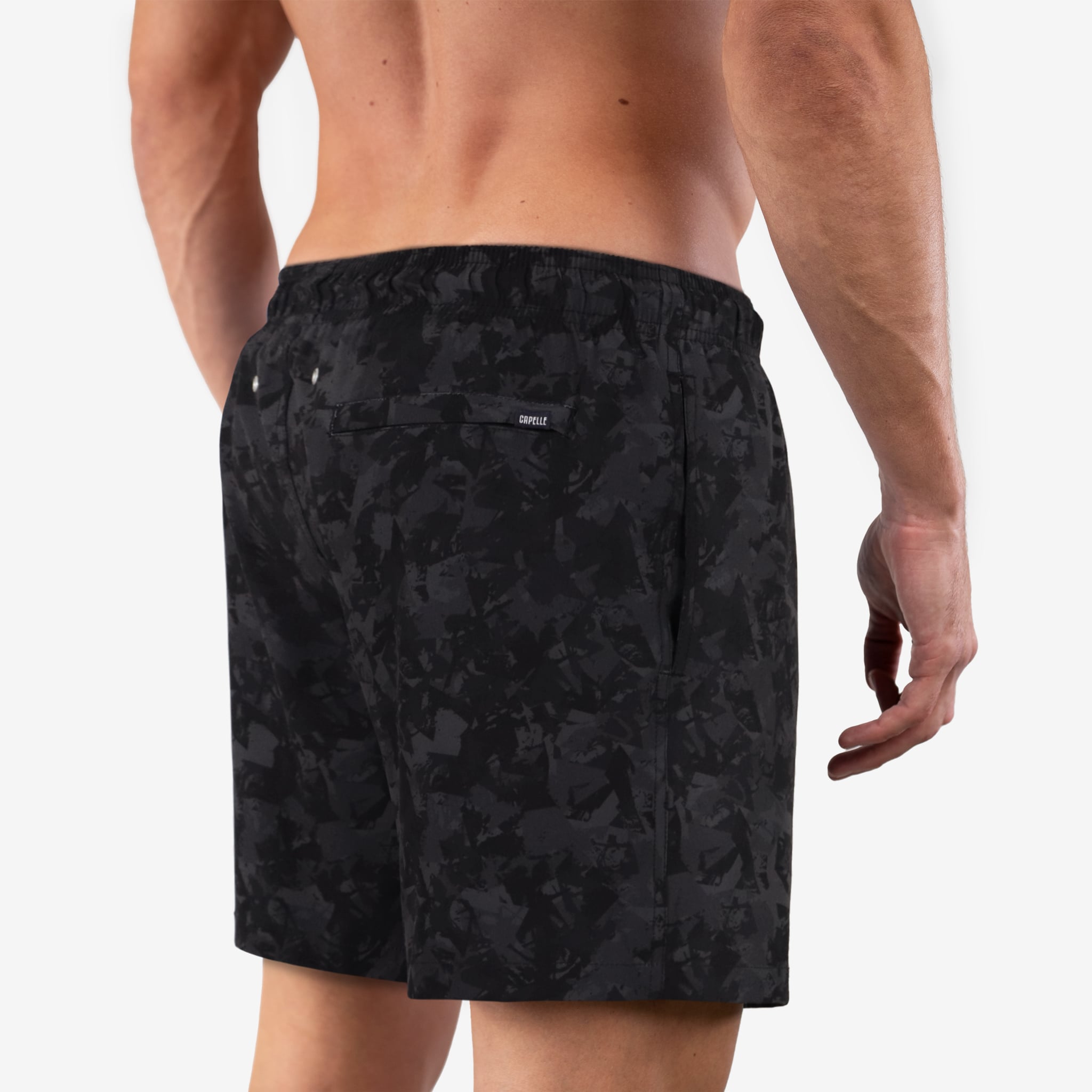 Black camouflage swim shorts worn by a person on a white background