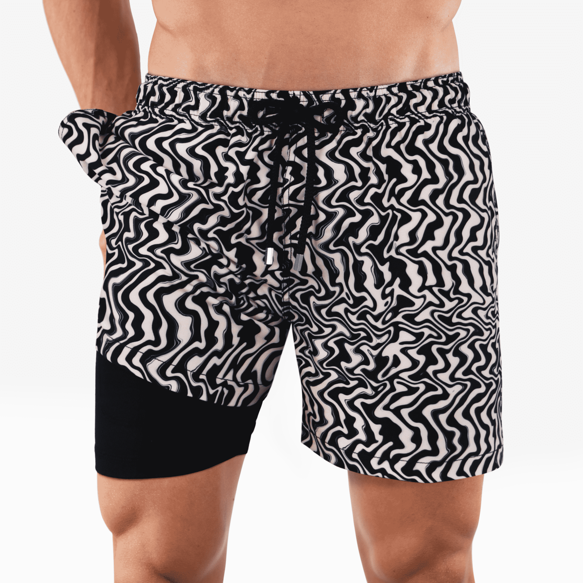 Black and white patterned swim shorts on a plain background