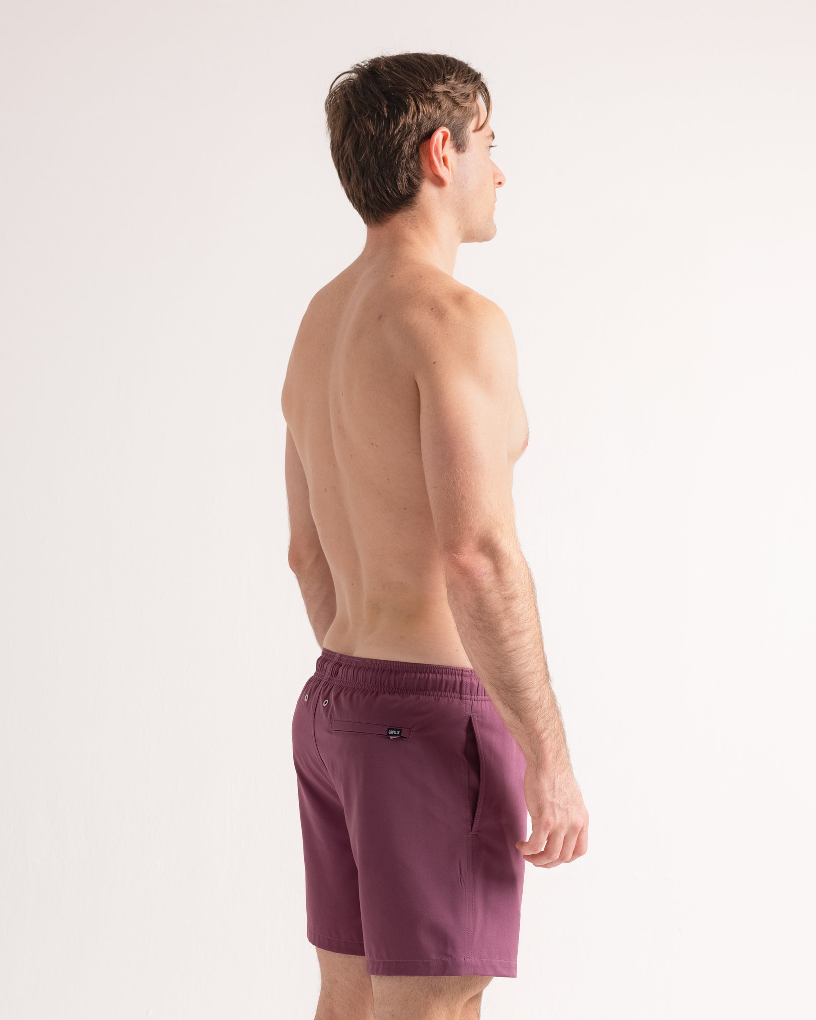 Man wearing purple shorts on a white background