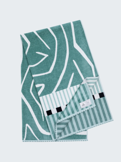 Teal towel with geometric pattern on a white background