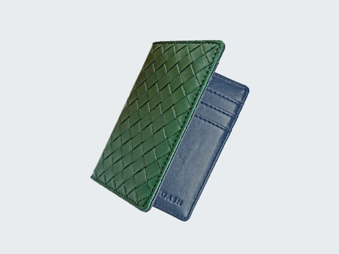 Green woven leather wallet and blue cardholder on a light gray background