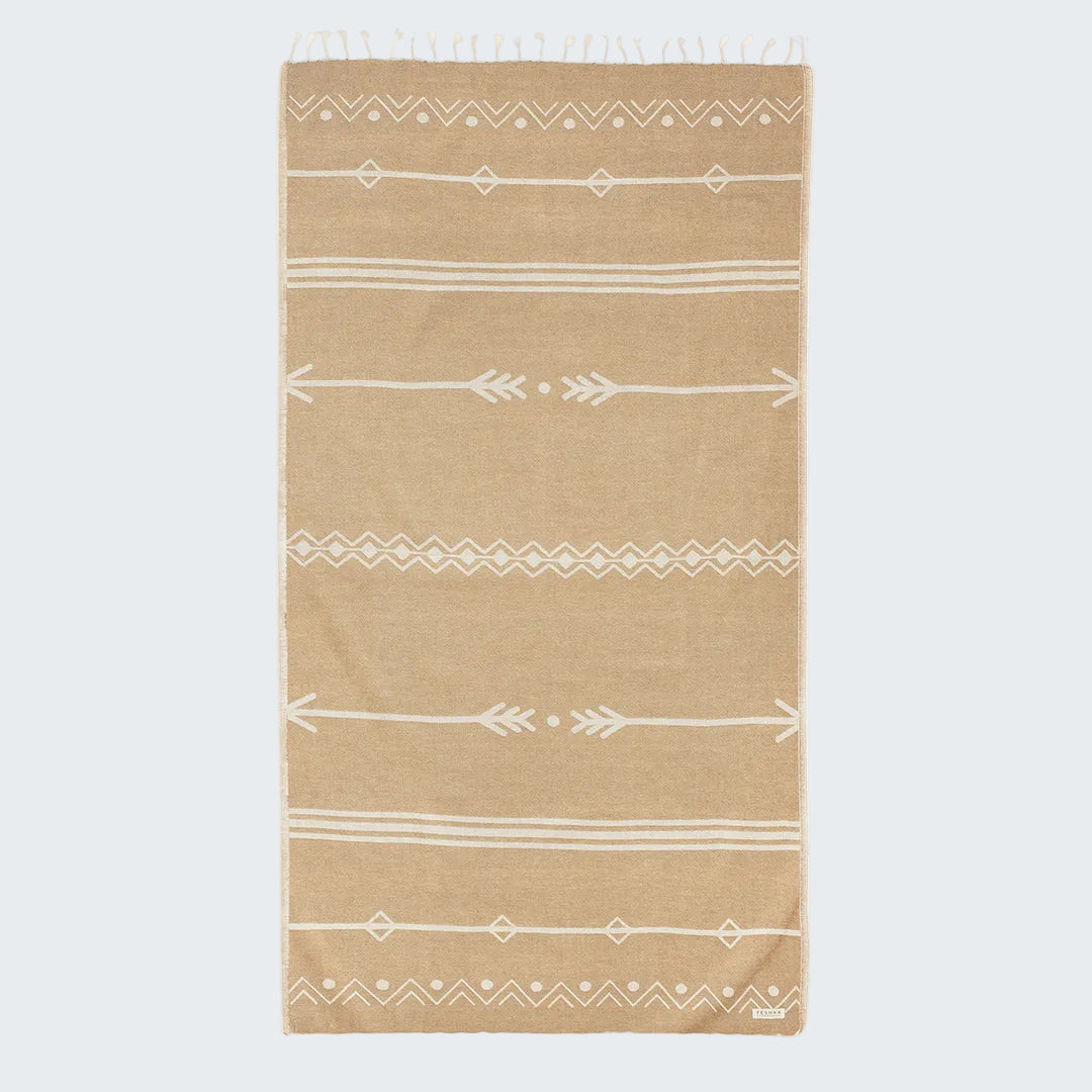 Beige towel with white geometric patterns on a white background