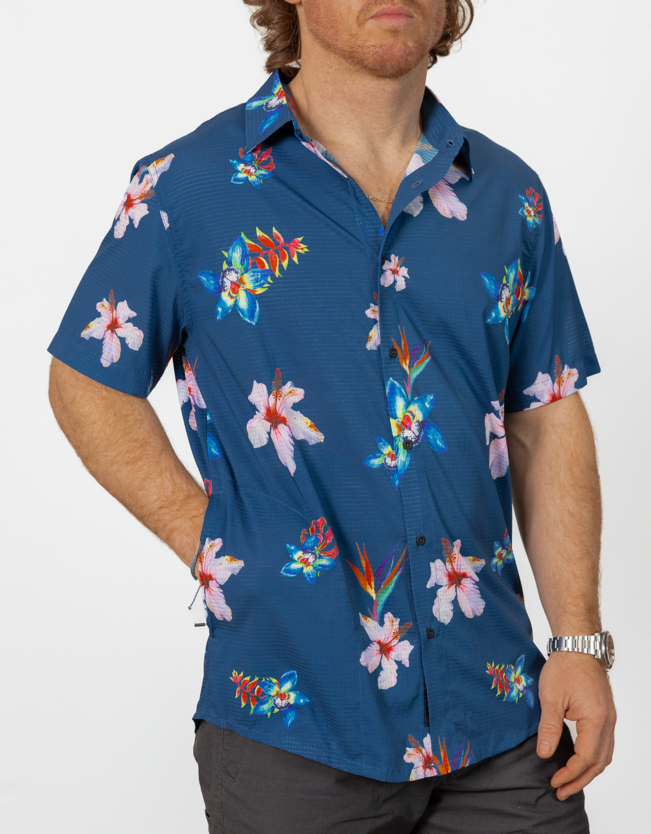 Man wearing a blue floral patterned shirt on a white background