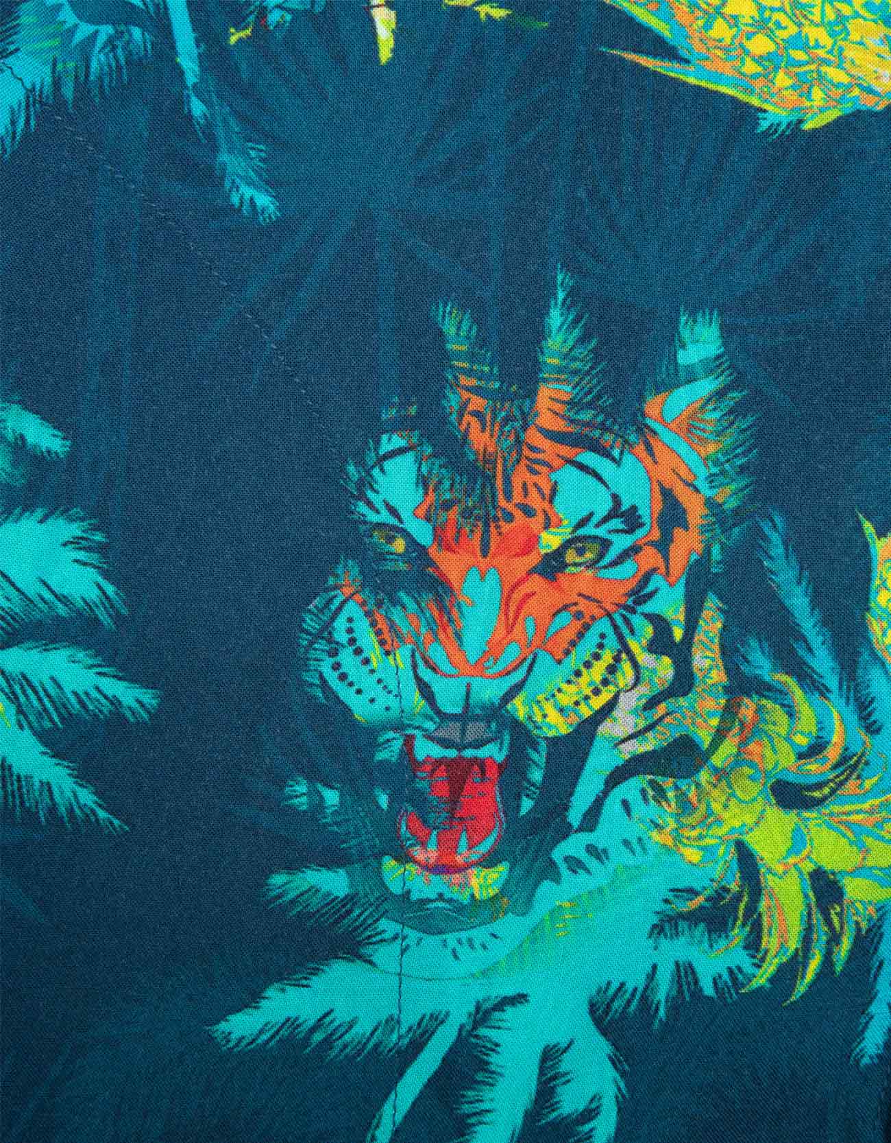 Colorful tiger design on a dark background with palm leaves