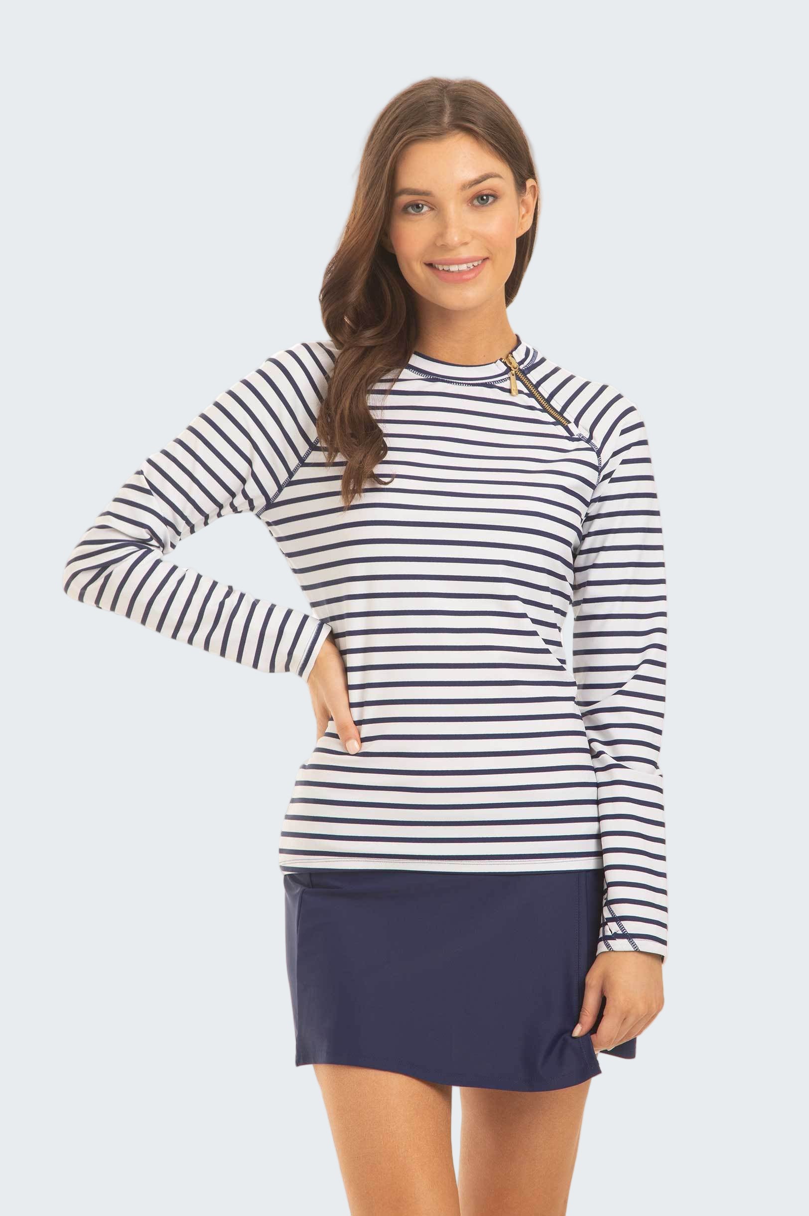 Woman wearing a striped long-sleeve top and navy skirt on a white background