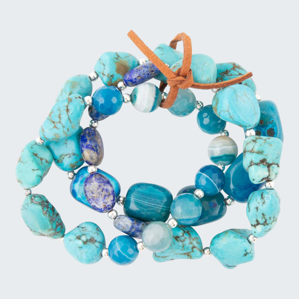 Turquoise beaded bracelet with a brown leather strap on a white background