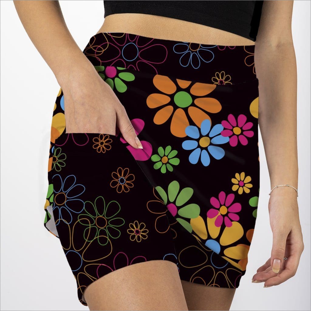 Black skirt with colorful floral pattern worn by a person on a white background