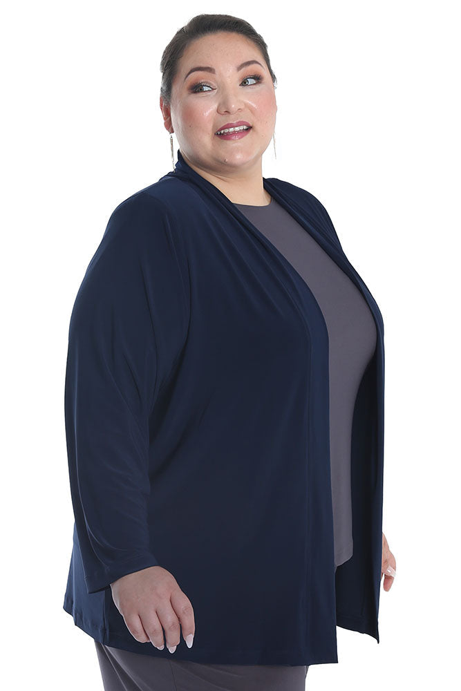 Woman wearing a navy blue cardigan over a gray top on a white background