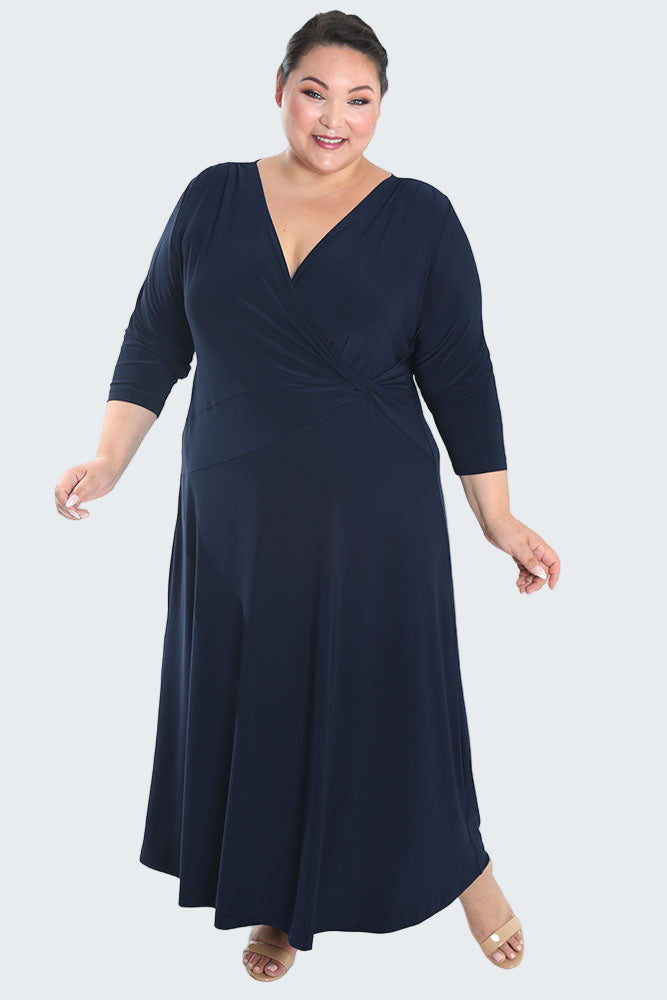 Woman wearing a navy blue dress on a white background
