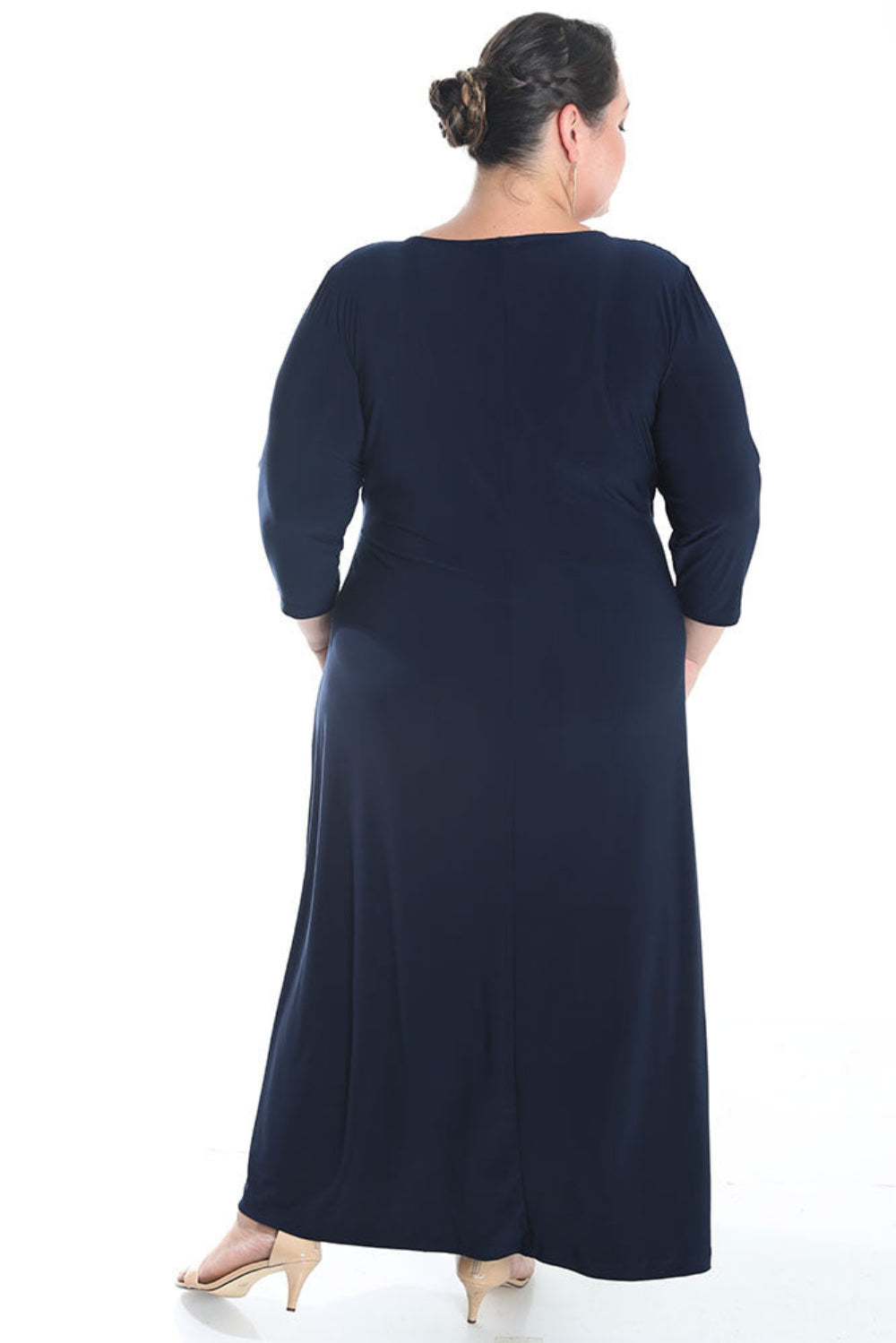 Woman wearing a navy blue dress with a white background
