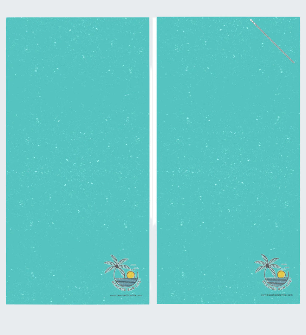 Two turquoise towels with a palm tree and sun design on a white background, labeled 'Ocean Vibes'.