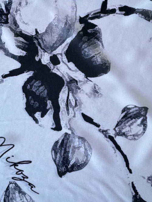 Black and white abstract design with floral elements on a textured background