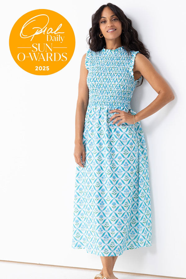 Woman wearing a blue patterned dress with 'Ghal Sun O' Awards 2025' badge on a white background
