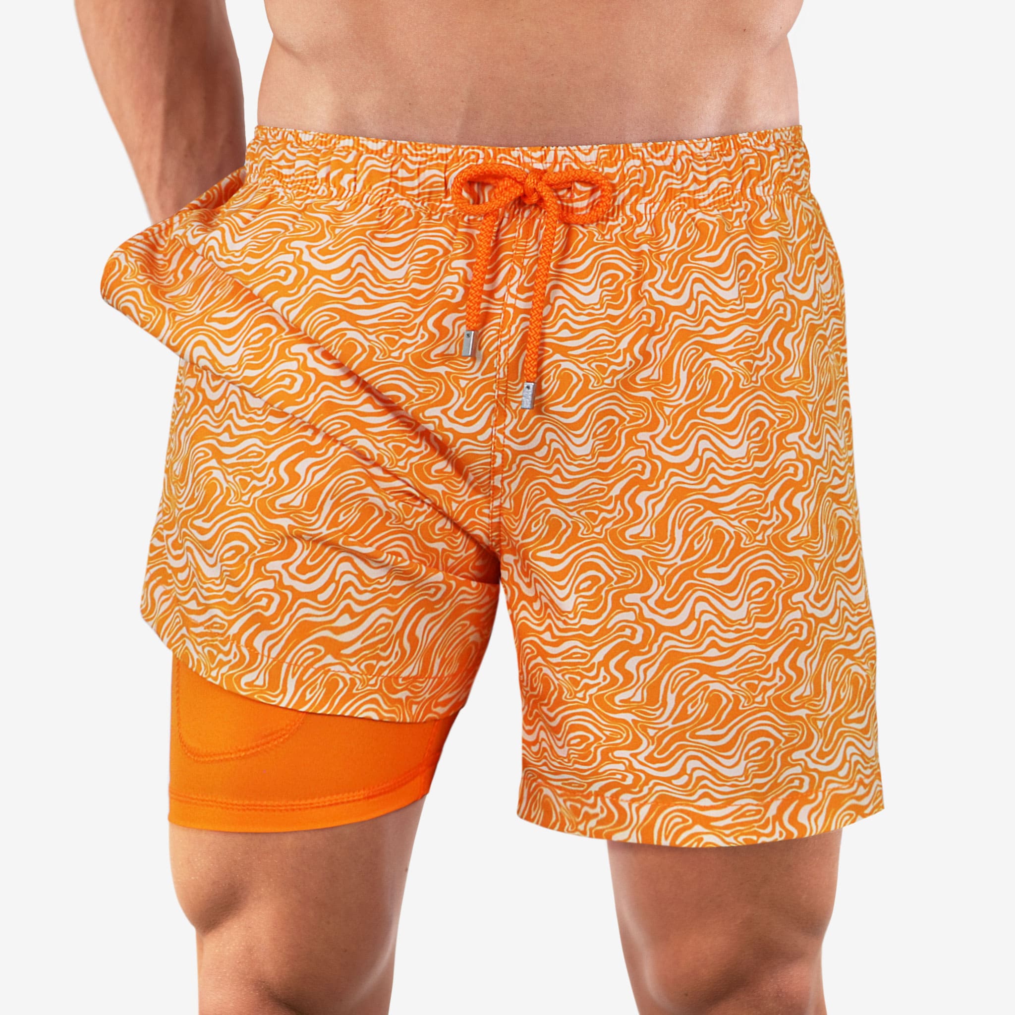 Orange patterned swim shorts worn by a person on a white background