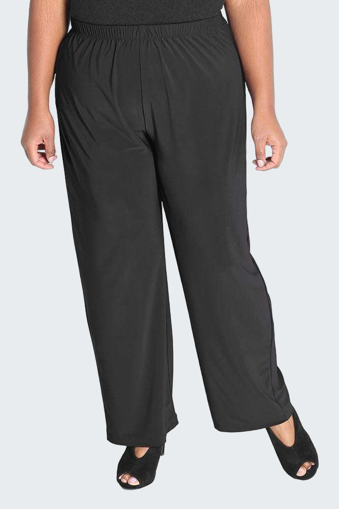 Person wearing black wide-leg pants on a white background