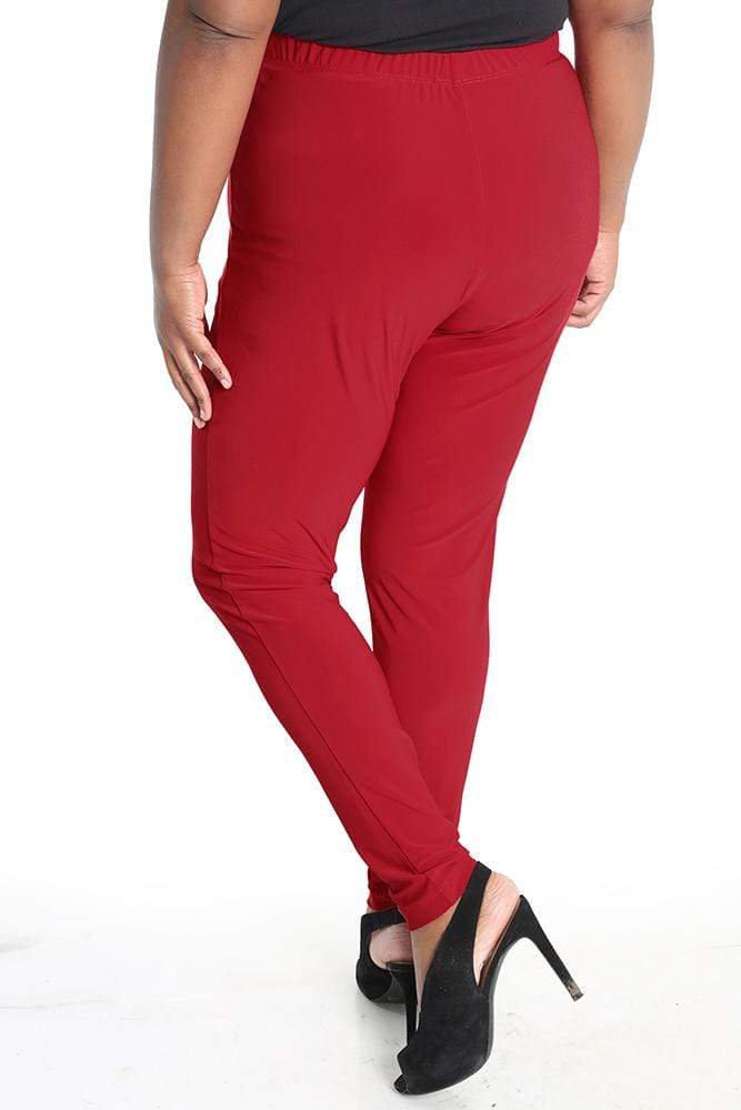 Red pants worn by a person on a white background