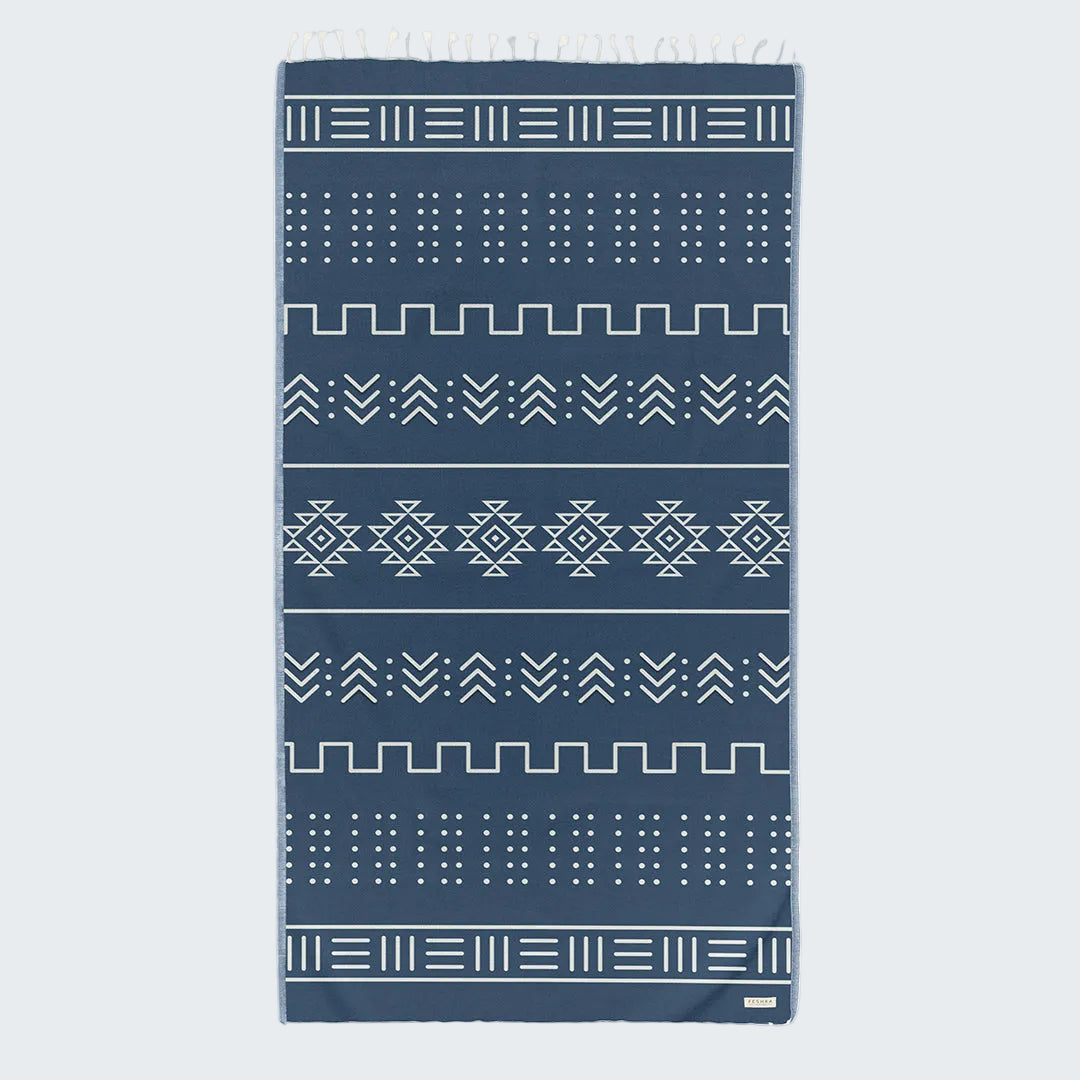 Navy blue towel with white geometric patterns on a white background