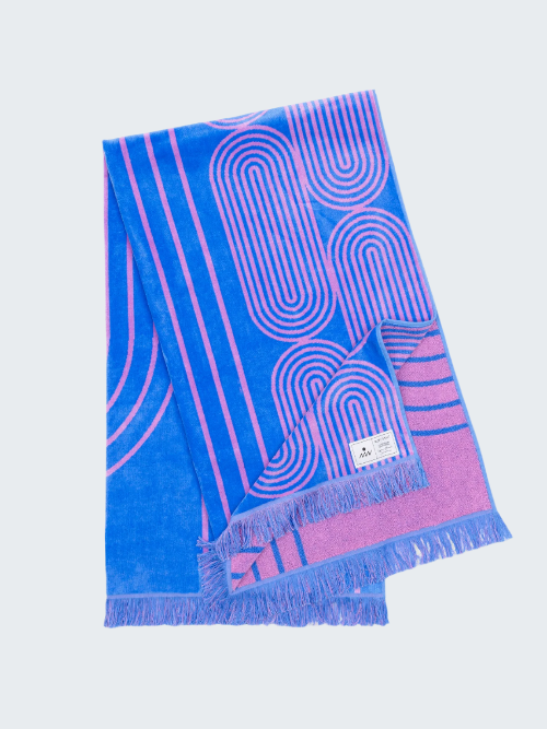 Blue and pink patterned towel with frayed edges on a white background