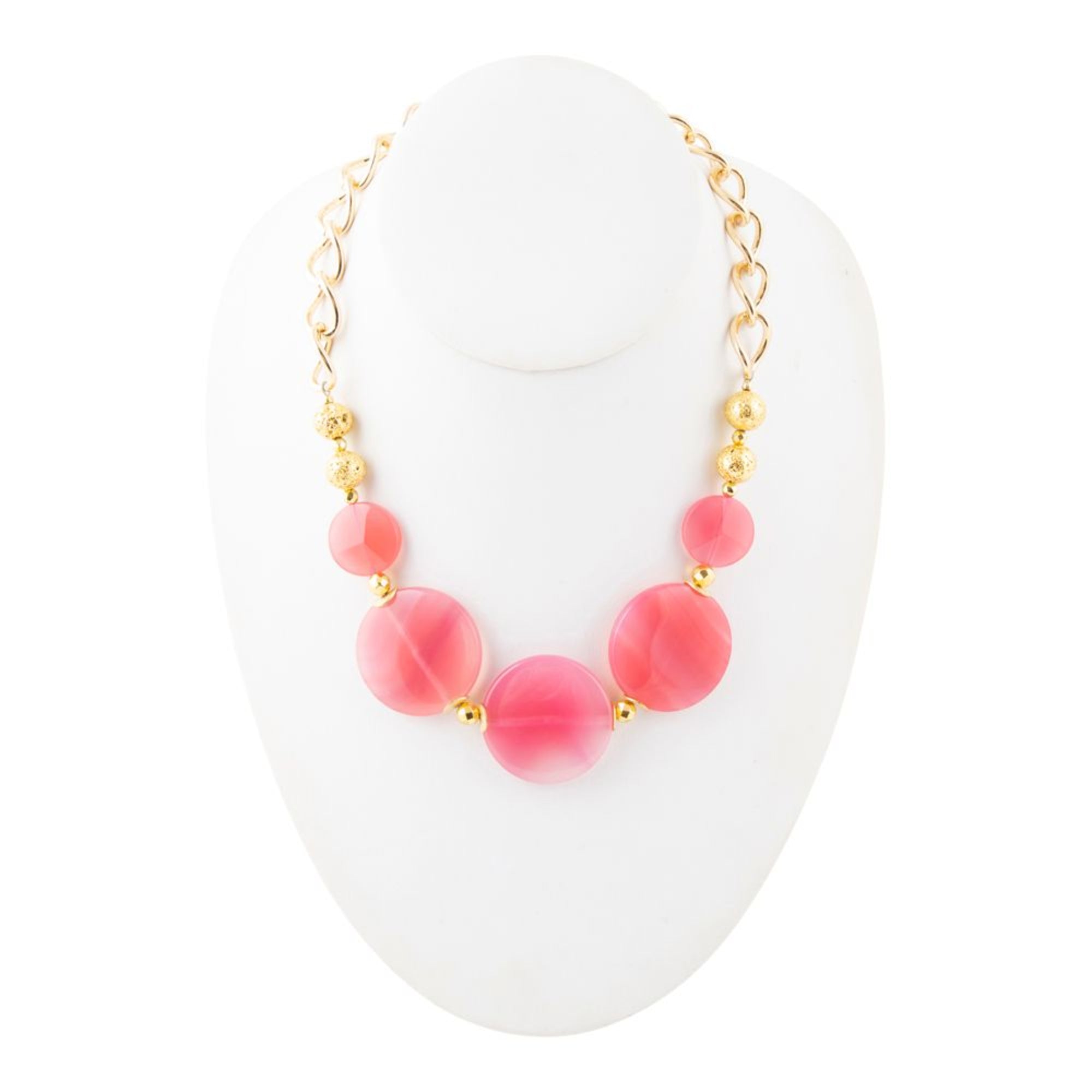 Necklace with pink beads and gold accents on a white stand