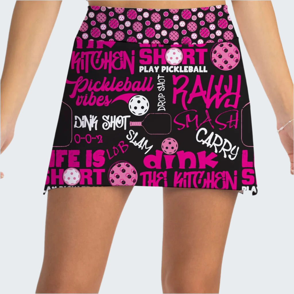 Pickleball-themed skirt with pink and white text and graphics on a black background.