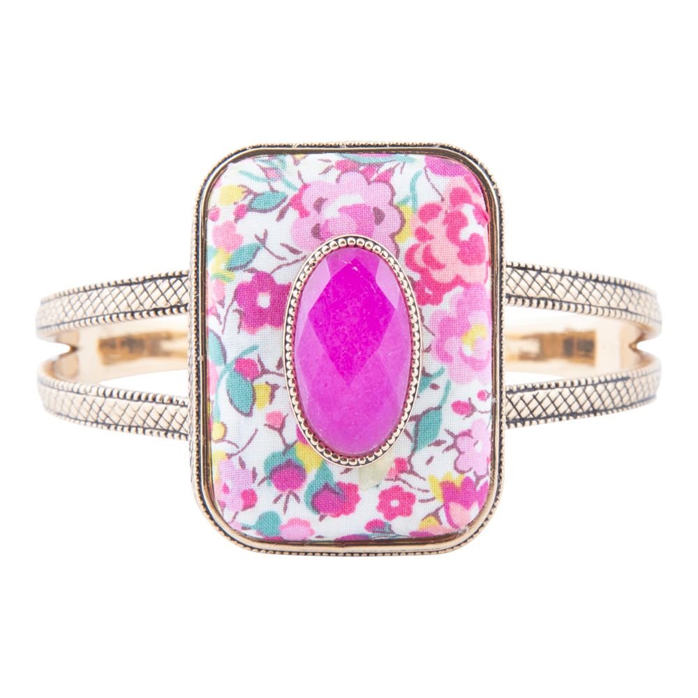 Bangle with floral pattern and pink central stone on a white background
