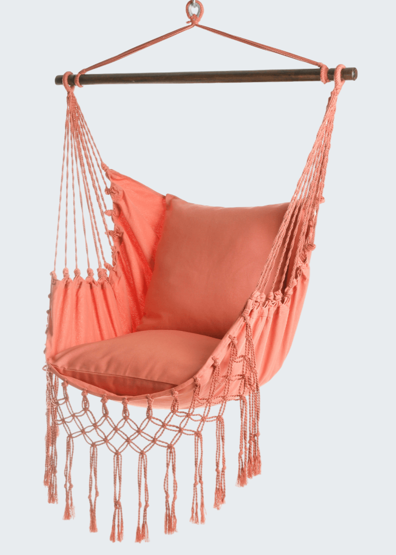 Coral hammock chair with tassels on a white background