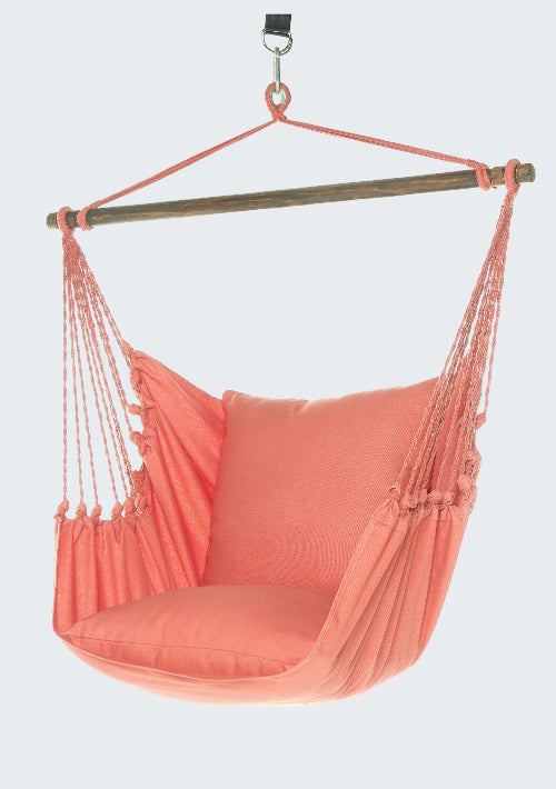Coral hammock chair with pillow on a white background