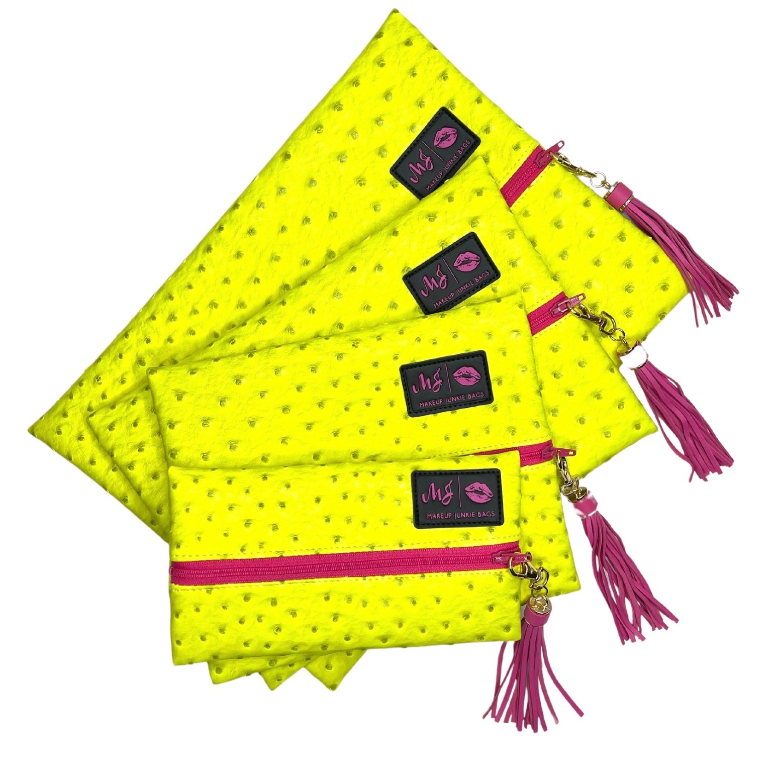 Yellow pouches with pink zippers and tassels on a white background