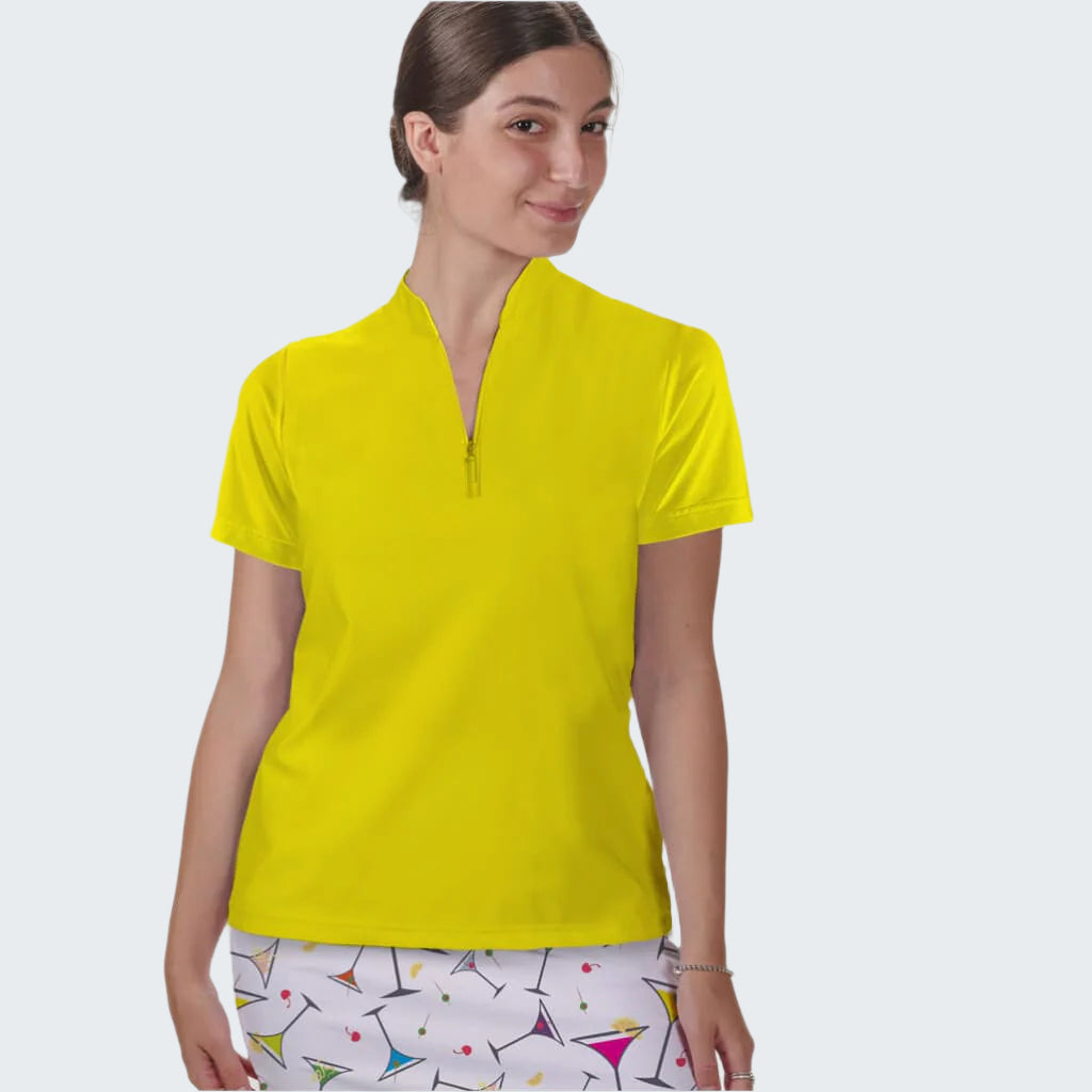 Woman wearing a bright yellow polo shirt against a plain background