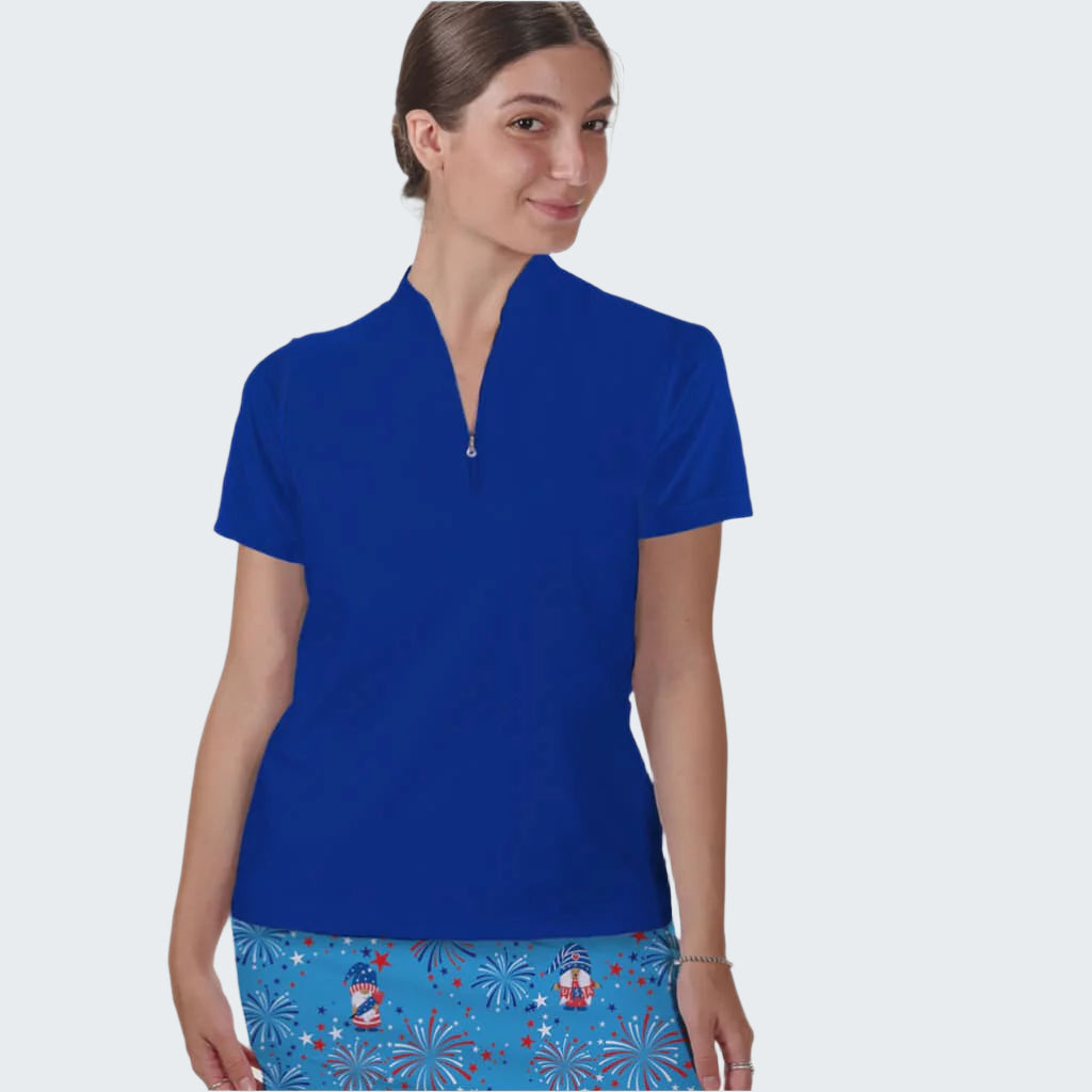 Woman wearing a blue top and colorful skirt on a white background