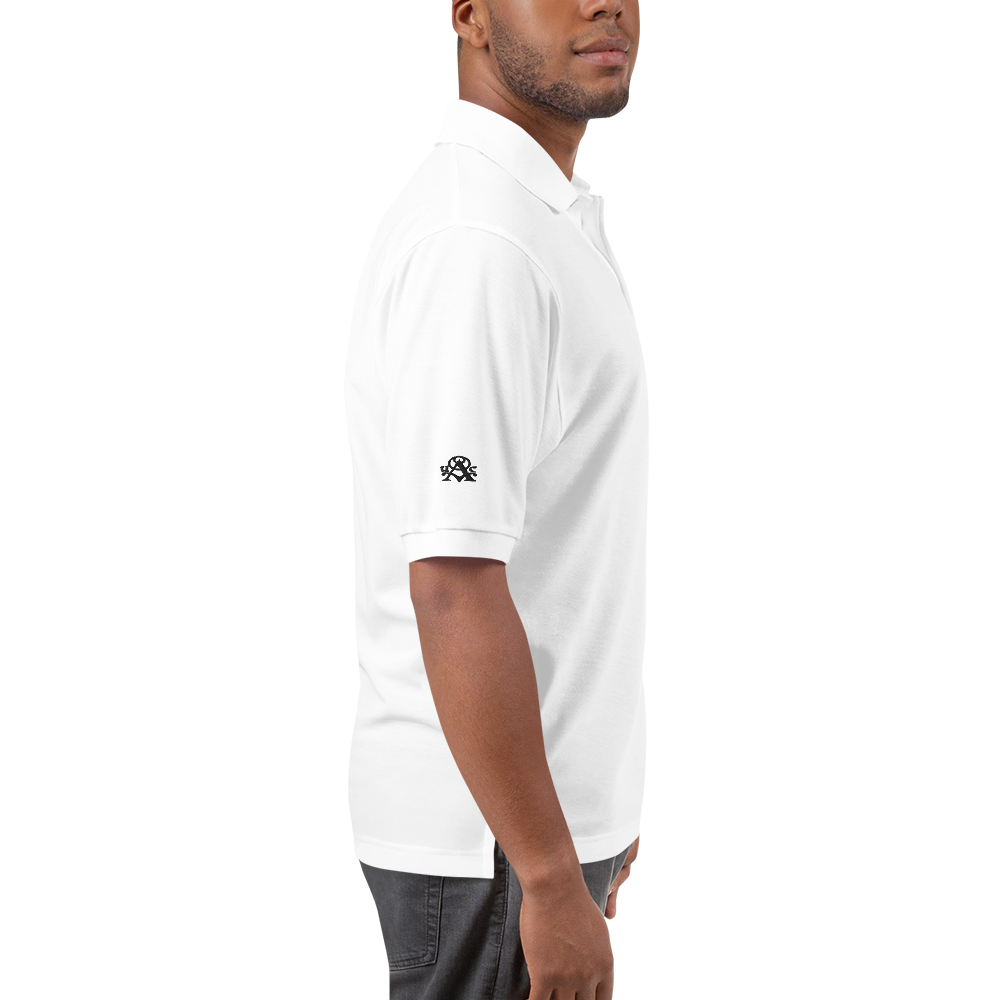 Man wearing a white polo shirt with a logo on the sleeve against a white background