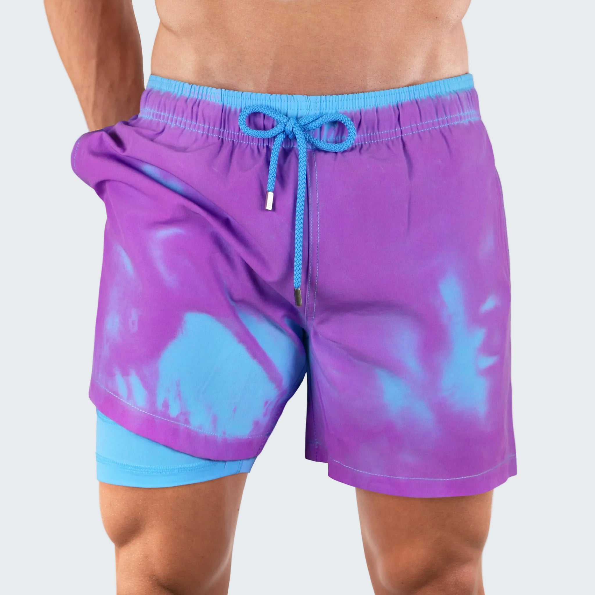 Purple and blue tie-dye swim shorts on a white background
