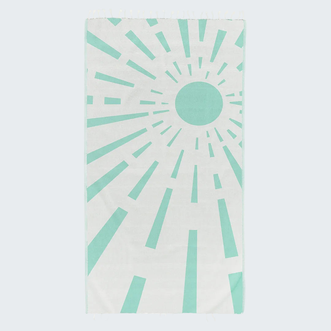 Towel with sunburst pattern in teal on a white background