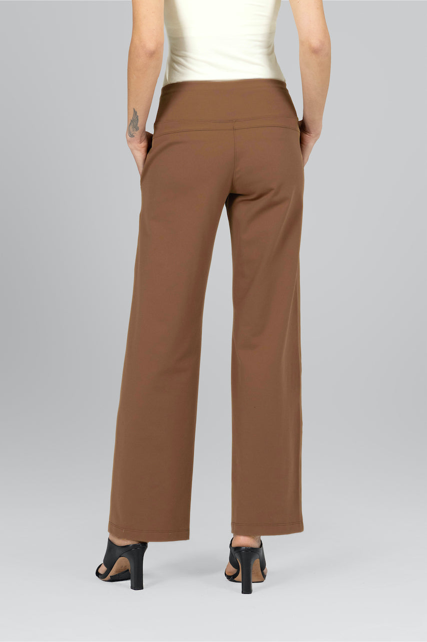 Brown pants worn by a person on a gray background