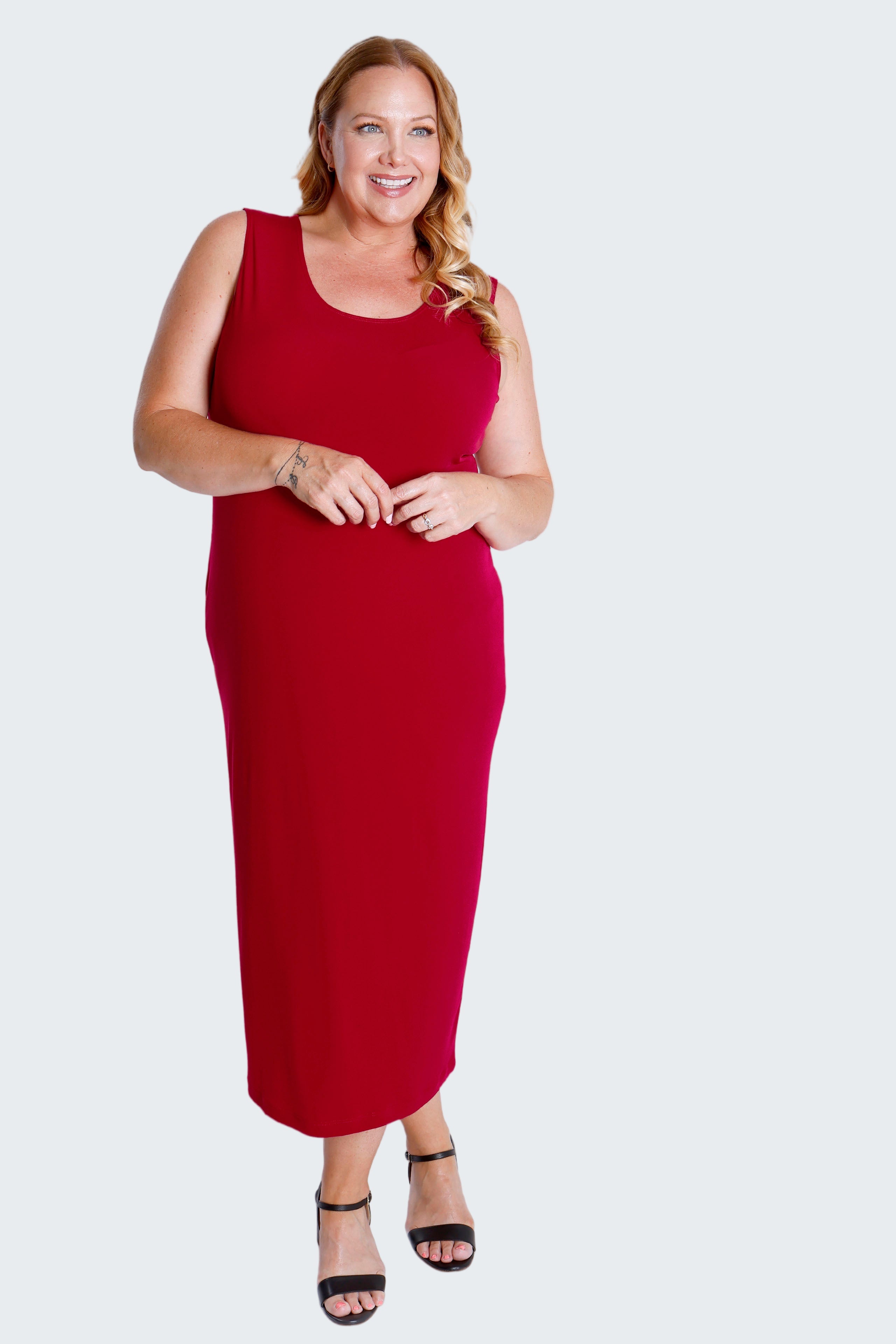 Woman wearing a red sleeveless dress on a white background