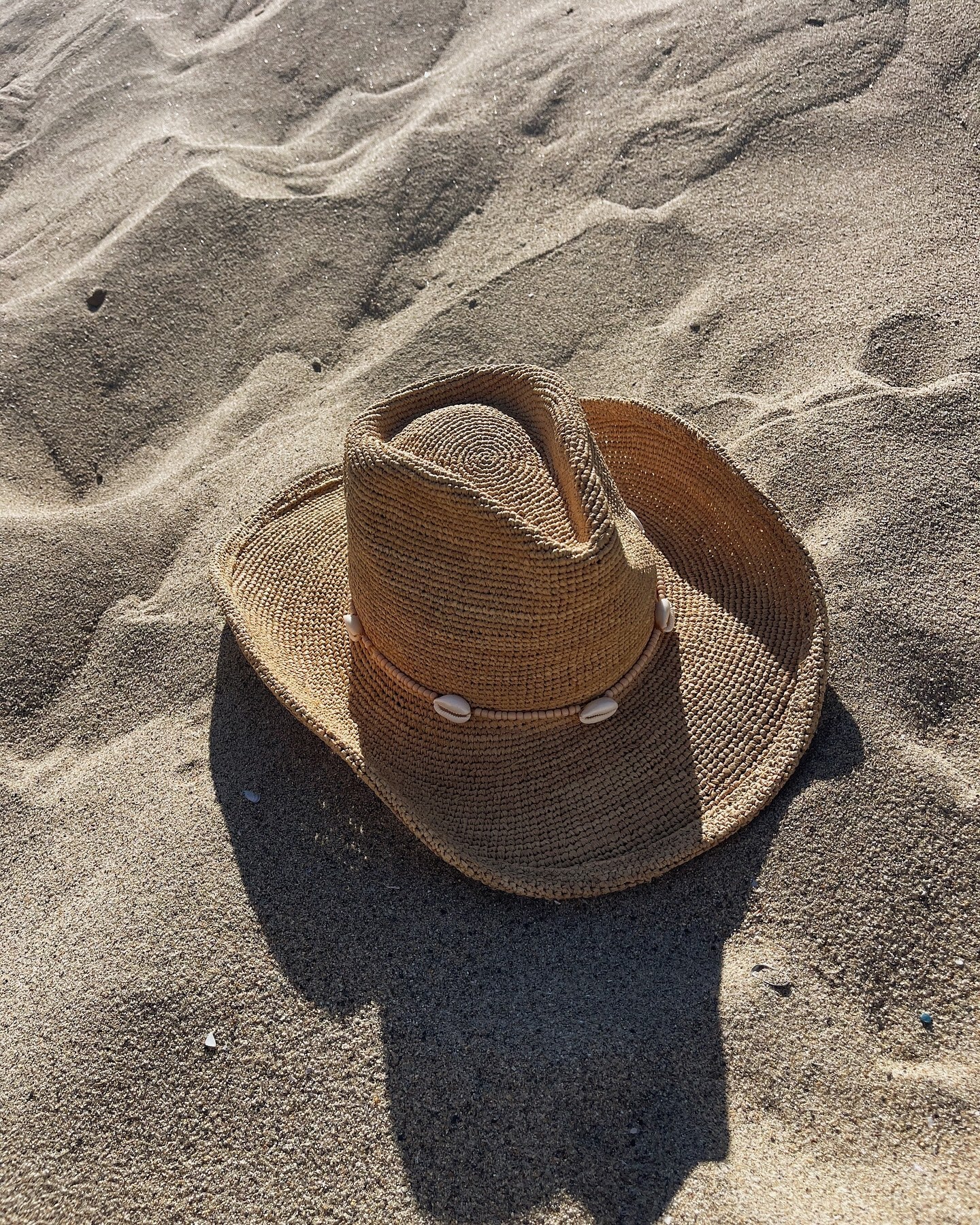 Brown straw hat on sandy ground
