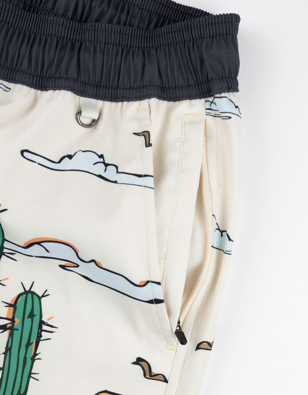 Close-up of a white pants with cartoon designs on a white background