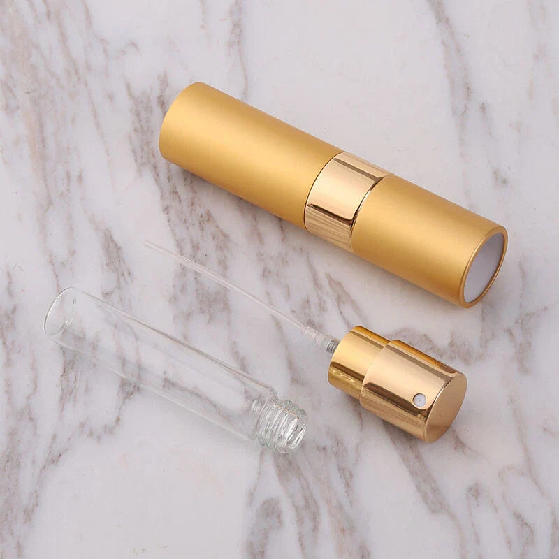 Gold and clear glass essential oil diffuser on a marble surface