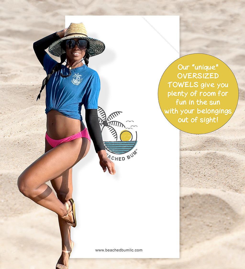 Woman in blue shirt and pink bikini on a beach with promotional text about oversized towels.