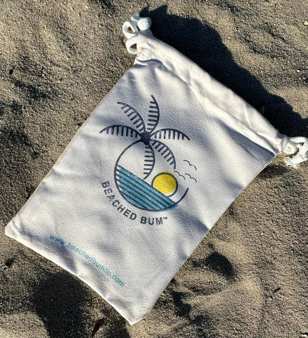 Beached Bum drawstring bag on sandy surface